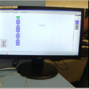 un ascenseur en mouvement et son écran d'ordinateur sur lequel est inscrit le logigramme correspondant à la programmation.